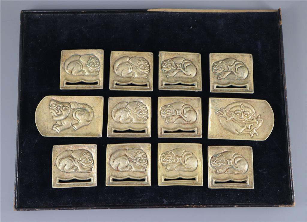 A set of twelve Chinese gilt bronze belt plaques, Tang-Liao dynasty or later, ten 6.3cm wide and two 9.5cm wide